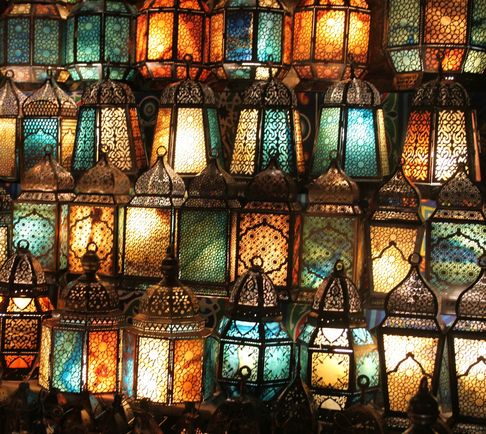 Ornate Arabian lanterns glowing with colored glass