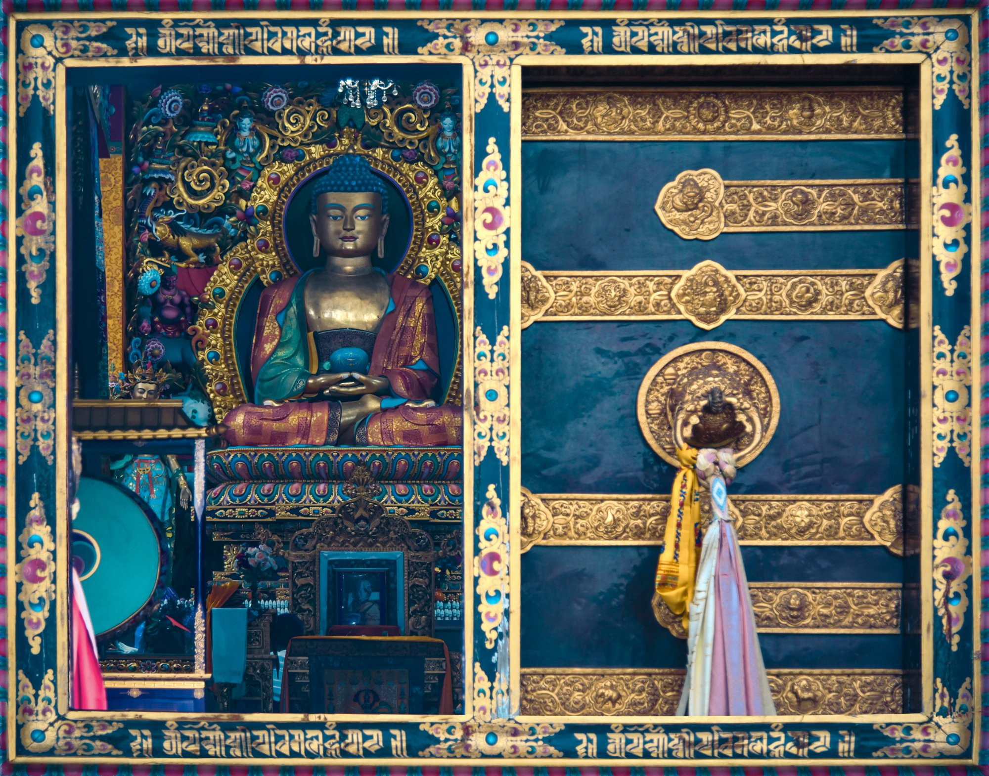 Golden Buddha statue in ornate Tibetan monastery