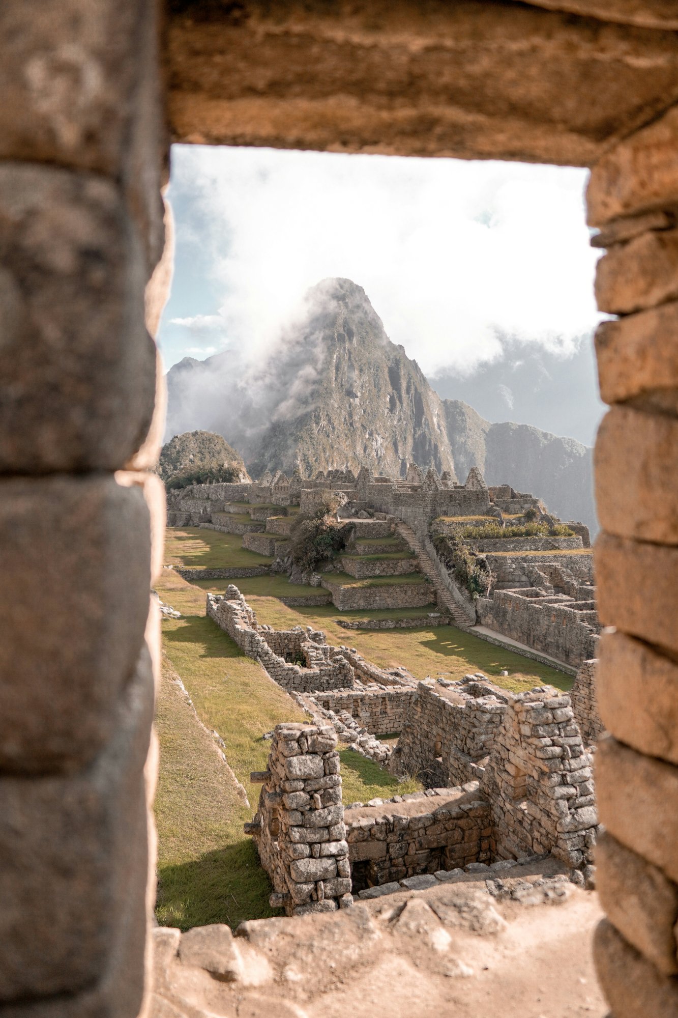 Machu Picchu ruins seen through a stone window – the Inca dreamscape between earth and sky