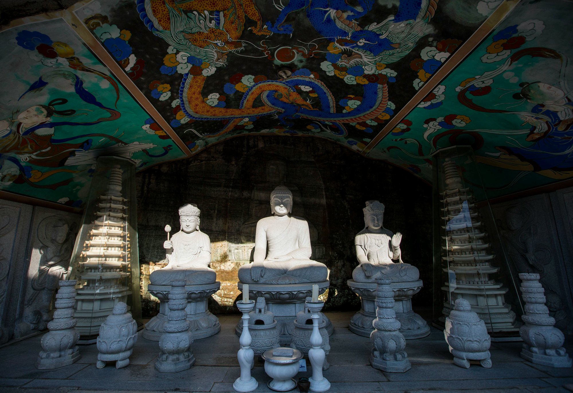 Korean temple with Buddha statues and painted dragon ceiling